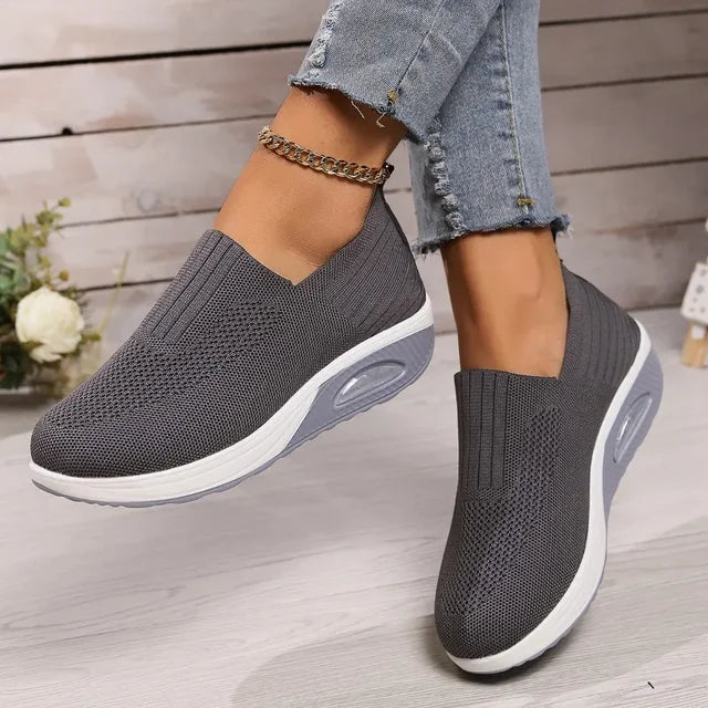 Women's breathable slip-on sneakers with cushioned sole, featuring lightweight mesh upper for cool, everyday comfort.