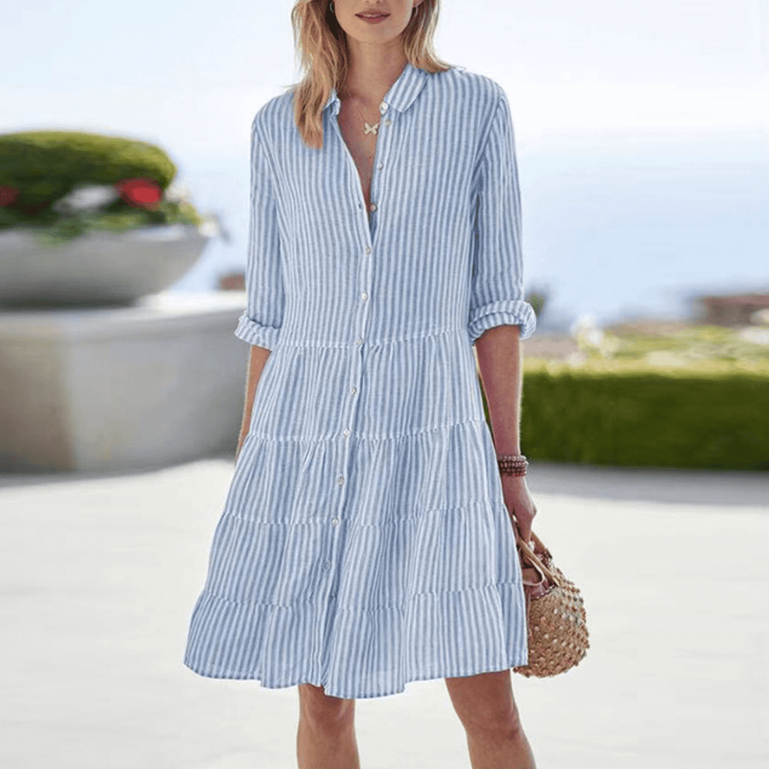 "Women's breezy chic summer dress with flattering neckline, featuring smooth fabric and sleek waist, ideal for warm weather."