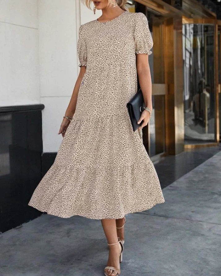 Women's casual boho midi dress with puff sleeves, soft print, and ruffle hem, creating an elegant silhouette.