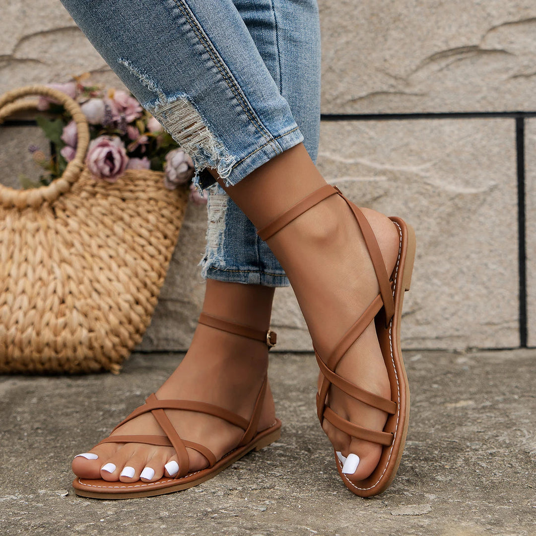 Women's casual Roman sandals with zipper back, strappy design, secure ankle strap, criss-cross detailing, flat sole.
