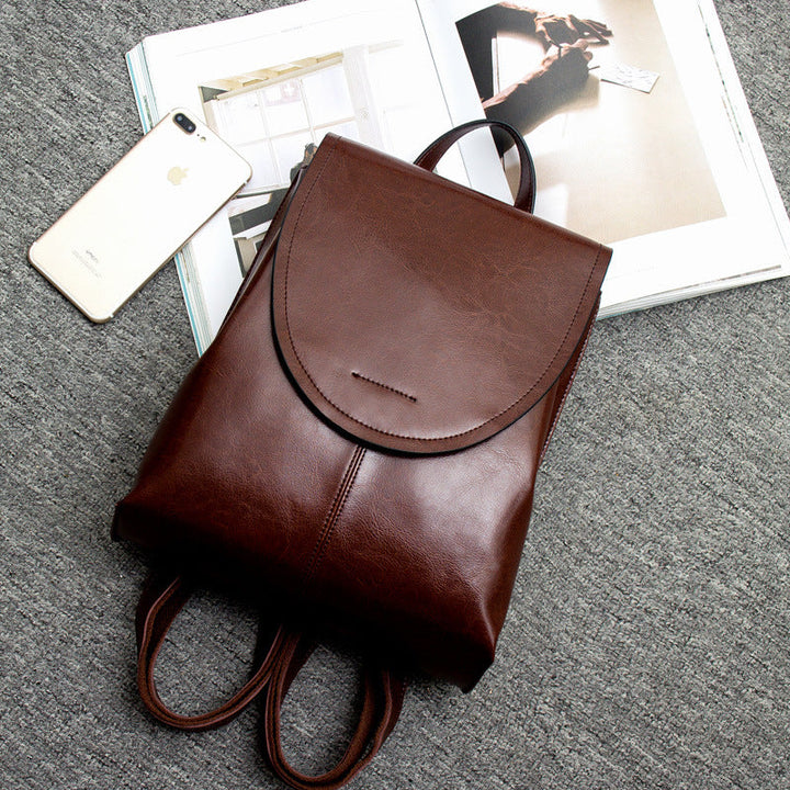 "Women's chic leather backpack, minimalist design, high-quality leather, adjustable straps, versatile for work and travel."