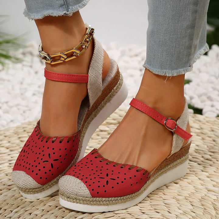 Women's closed-toe espadrille wedge sandals with ankle strap, featuring a stylish perforated toe and secure buckle fit.