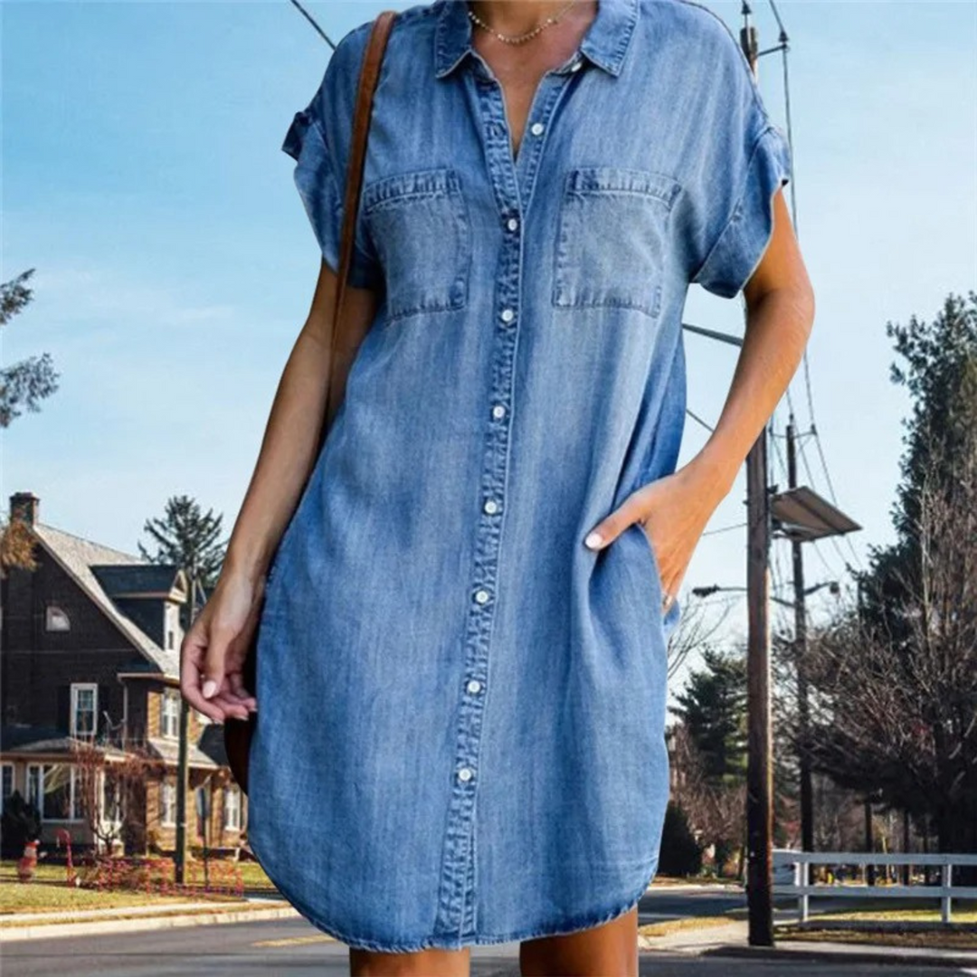 Women's denim short sleeve shirt dress with button-down front, relaxed fit, and chest pockets for a casual yet elegant look.