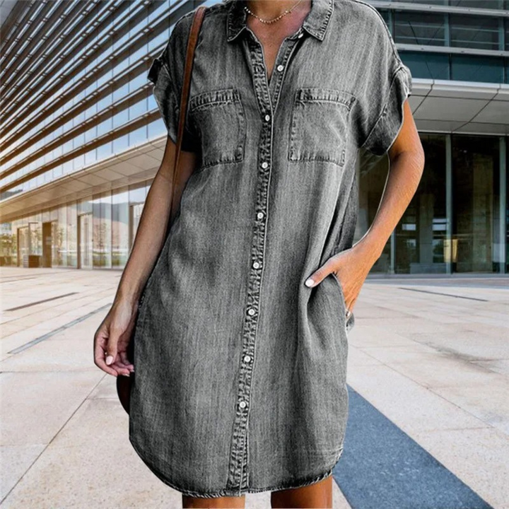 Women's denim short sleeve shirt dress with button-down front, relaxed fit, and chest pockets for a casual yet elegant look.