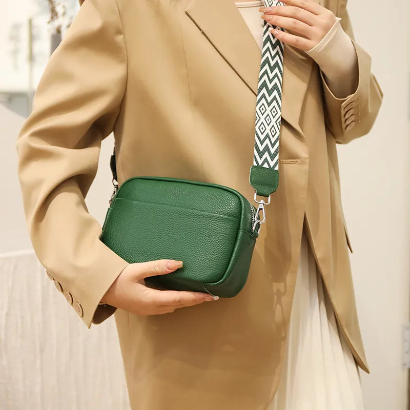 "Women's elegant beige leather crossbody bag with pebbled texture and adjustable strap, perfect for versatile fashion styling