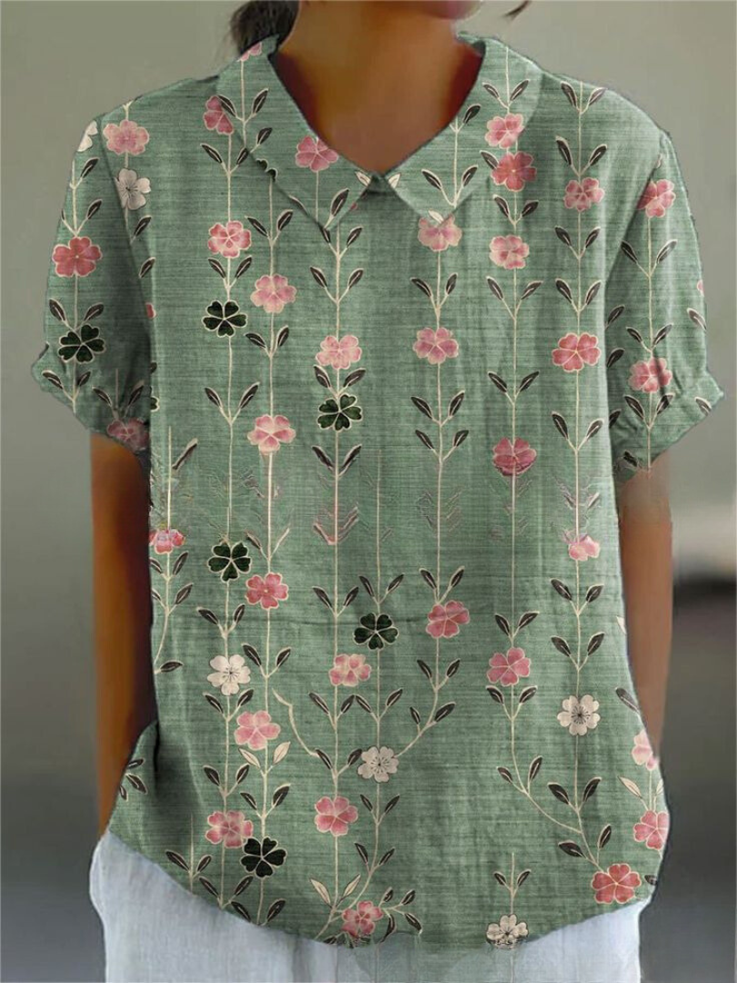 Women's elegant floral blouse with short sleeves and Peter Pan collar, featuring a vibrant floral pattern for stylish summer 
