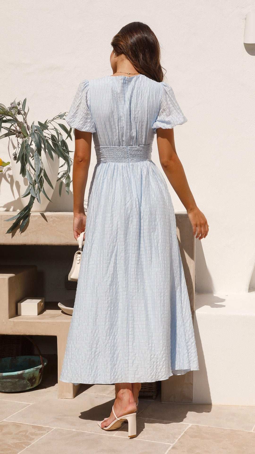 Women's elegant flowy maxi dress with button-front, showcasing a graceful silhouette ideal for versatile fashion wear.