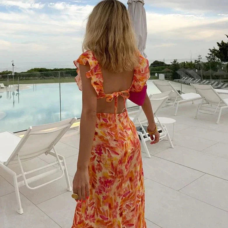 Women's elegant ruffled maxi dress with batwing sleeves, featuring bohemian charm, a V-neckline, and a flowing silhouette.