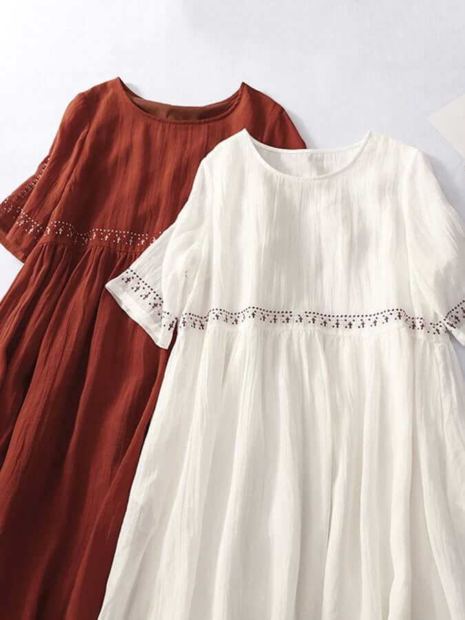 "Women's embroidered loose dress with cotton linen blend, intricate embroidery detailing, comfortable and elegant look."