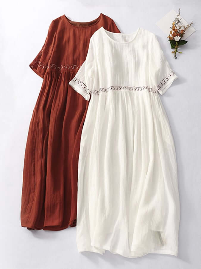 "Women's embroidered loose dress with cotton linen blend, intricate embroidery detailing, comfortable and elegant look."