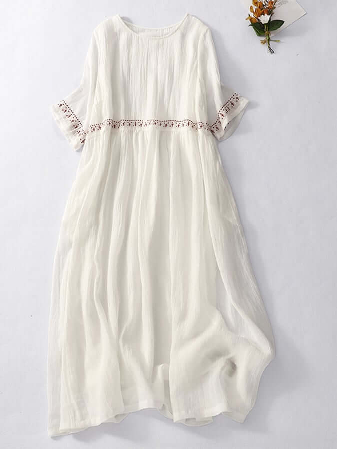 "Women's embroidered loose dress with cotton linen blend, intricate embroidery detailing, comfortable and elegant look."