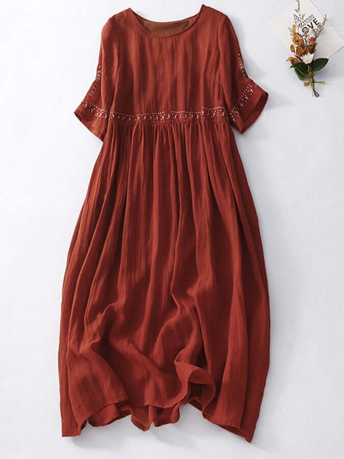 "Women's embroidered loose dress with cotton linen blend, intricate embroidery detailing, comfortable and elegant look."