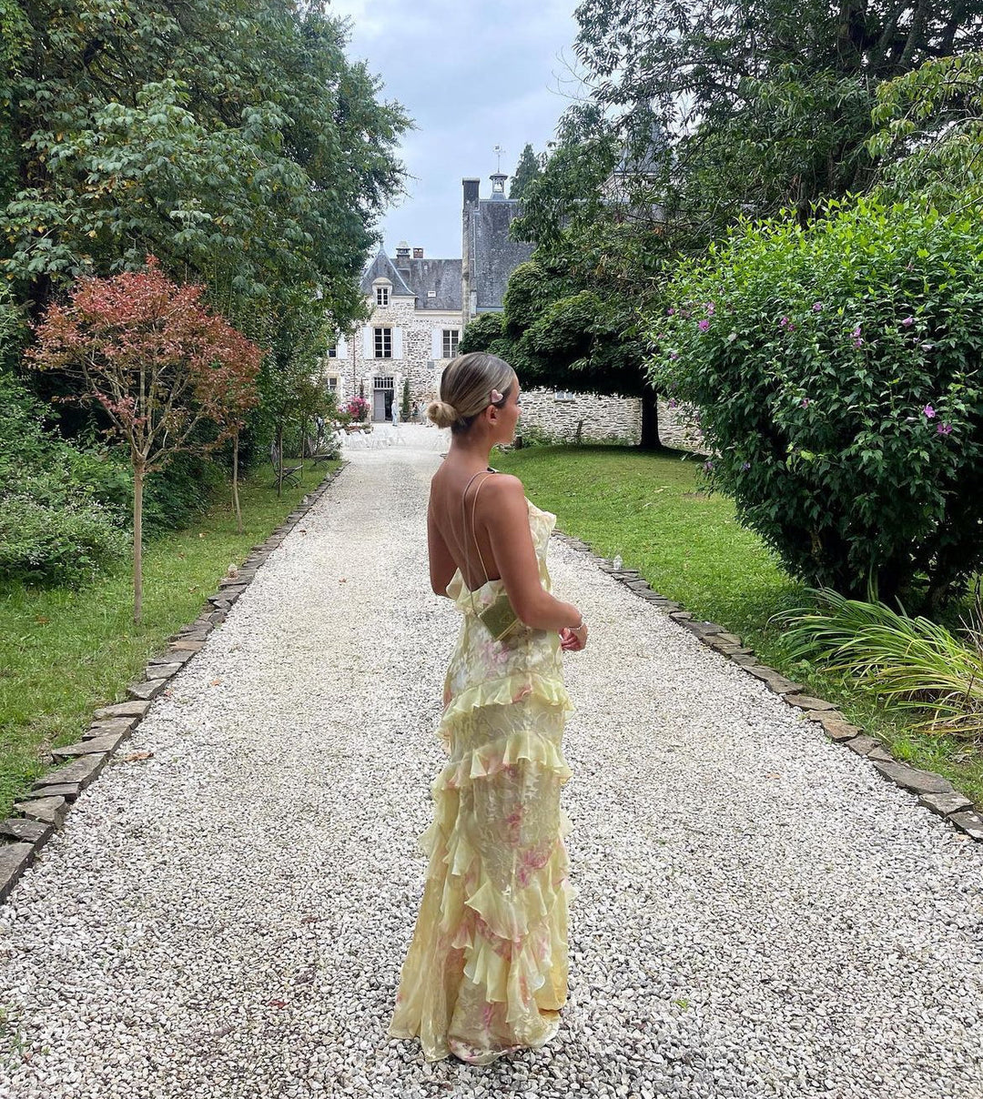"Women's ethereal ruffle maxi dress, romantic flowing design, airy ruffles, open-back detail, soft romantic hues for elegance