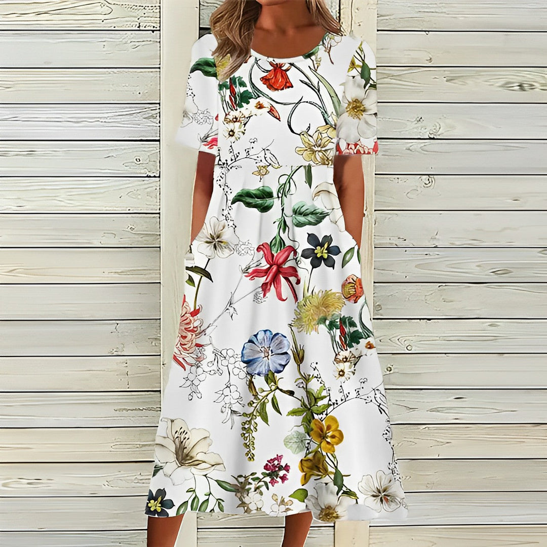 "Women's floral midi dress with pockets, featuring short sleeves and round neck; elegant design for casual wear."