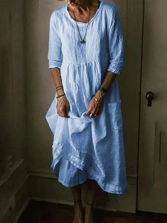 "Women's Loose Fit Cotton Linen Midi Dress with round neck, 3/4 sleeves, asymmetric hem, and pockets in various colors."