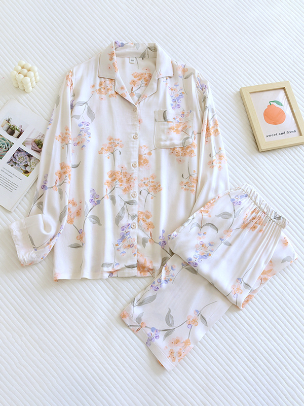Women's luxurious cotton long-sleeve pyjama set, soft breathable fabric, elegant two-piece design in light pastel colors.