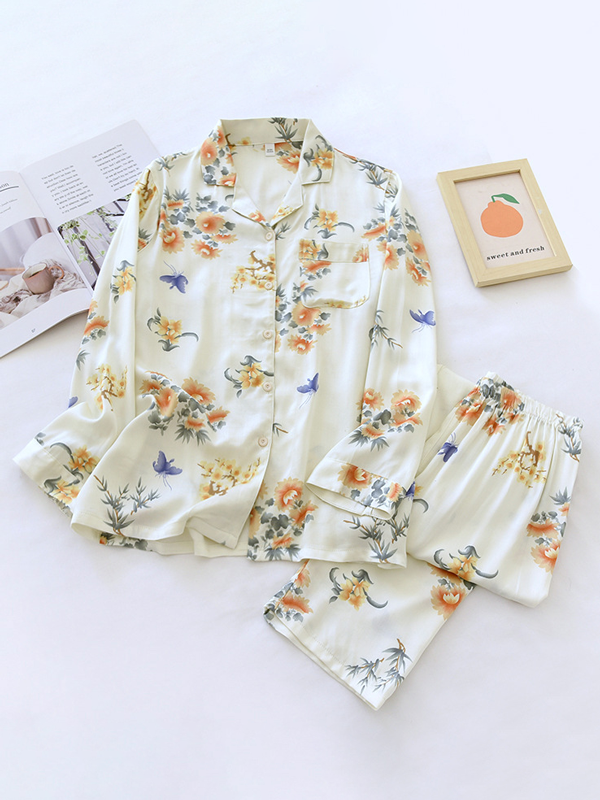 Women's luxurious cotton long-sleeve pyjama set, soft breathable fabric, elegant two-piece design in light pastel colors.