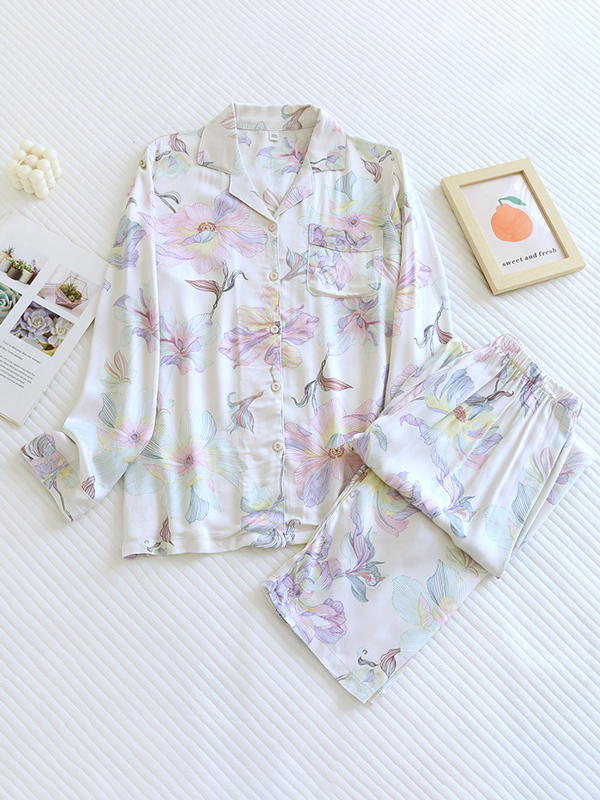 Women's luxurious cotton long-sleeve pyjama set, soft breathable fabric, elegant two-piece design in light pastel colors.