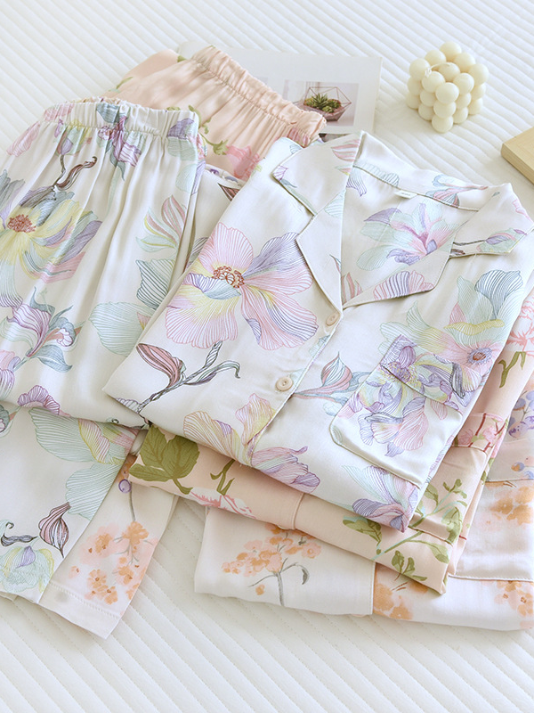 Women's luxurious cotton long-sleeve pyjama set, soft breathable fabric, elegant two-piece design in light pastel colors.