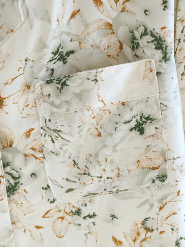Women's luxurious cotton long-sleeve pyjama set, soft breathable fabric, elegant two-piece design in light pastel colors.
