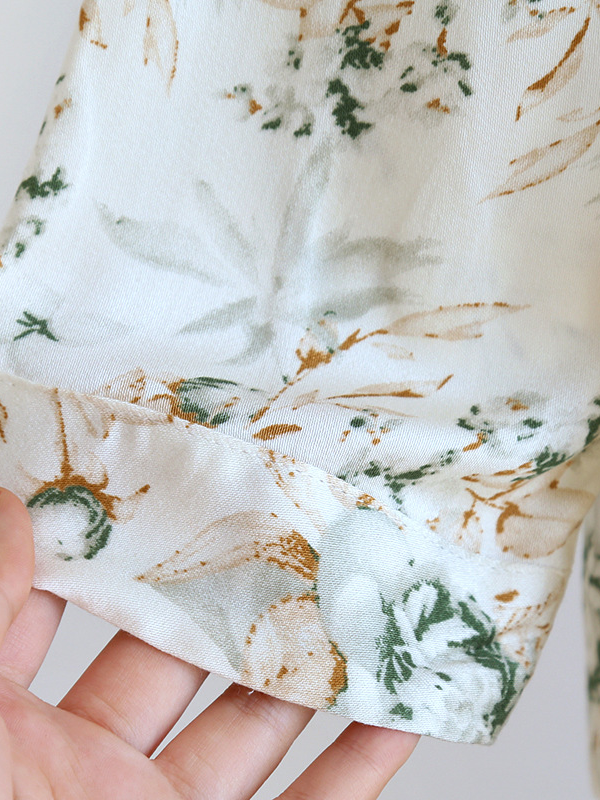Women's luxurious cotton long-sleeve pyjama set, soft breathable fabric, elegant two-piece design in light pastel colors.