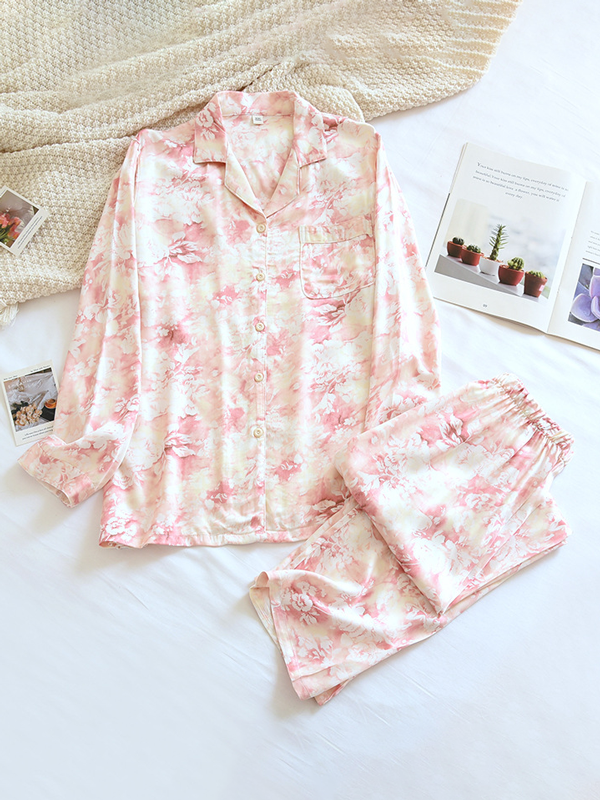 Women's luxurious cotton long-sleeve pyjama set, soft breathable fabric, elegant two-piece design in light pastel colors.
