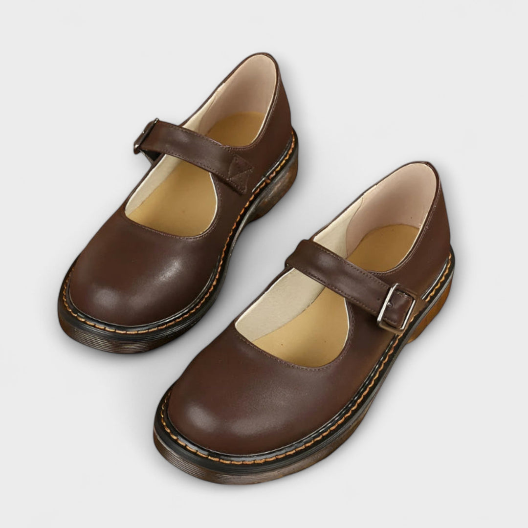 Women's Mary Jane flats with vintage buckle strap, flat sole, and chic design in black and brown shades, ideal for all-day we