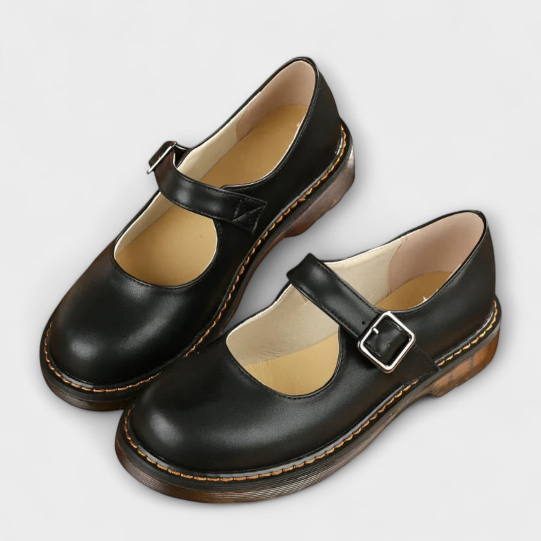 Women's Mary Jane flats with vintage buckle strap, flat sole, and chic design in black and brown shades, ideal for all-day we