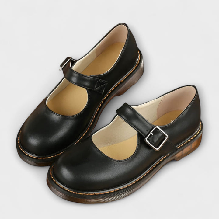 Women's Mary Jane flats with vintage buckle strap, flat sole, and chic design in black and brown shades, ideal for all-day we