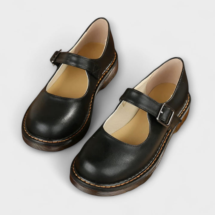 Women's Mary Jane flats with vintage buckle strap, flat sole, and chic design in black and brown shades, ideal for all-day we