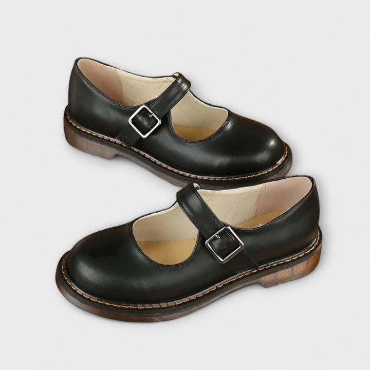 Women's Mary Jane flats with vintage buckle strap, flat sole, and chic design in black and brown shades, ideal for all-day we