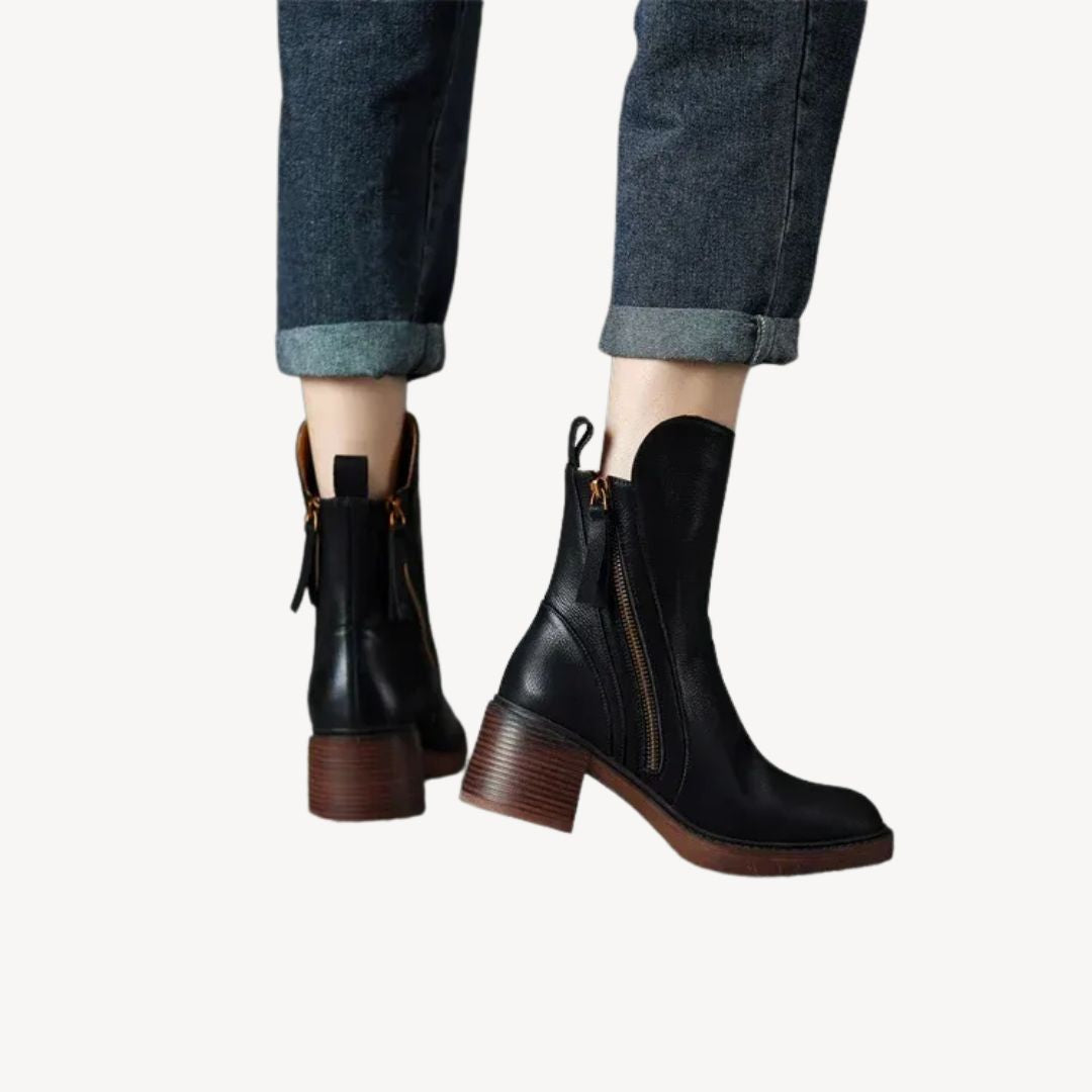 "Women's orthopedic black leather ankle boots with side zipper and moderate heel for comfort and style."