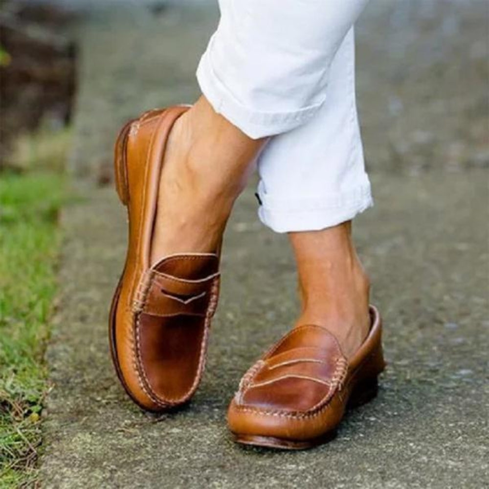 Women's orthopedic leather slip-ons with cushioned insole, sleek design, and soft leather for ultimate comfort and style.