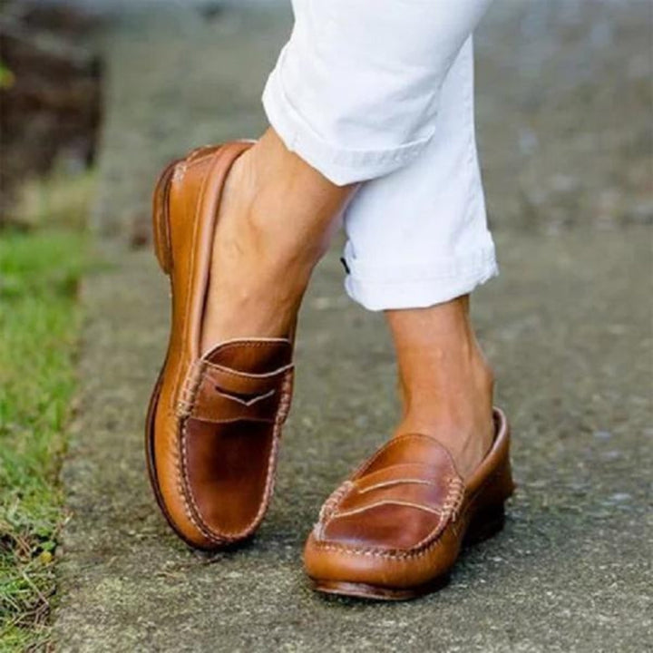 Women's orthopedic leather slip-ons with cushioned insole, sleek design, and soft leather for ultimate comfort and style.