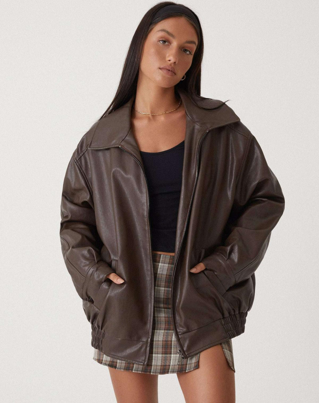 Women's oversized leather jacket in chocolate brown; luxurious, modern, and versatile with stylish front pockets.