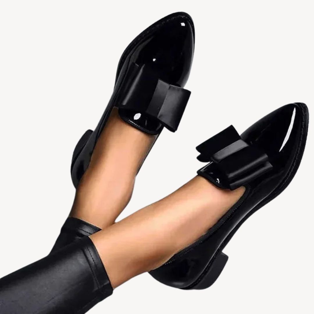 Women's patent leather loafers with bow, in burgundy and black, sleek high-shine finish, elegant and comfortable footwear.