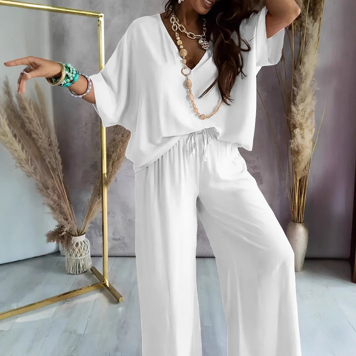 Women's relaxed fit lounge set; cotton blend V-neck top, batwing sleeves, wide-leg pants, ideal for casual wear.