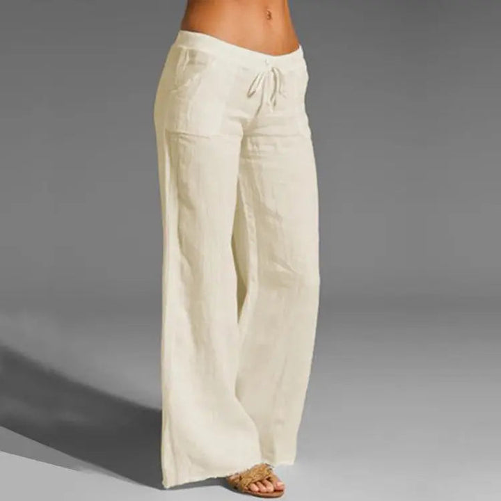 "Women's relaxed linen trousers with elastic waistband, featuring a loose fit and breathable material for summer comfort."