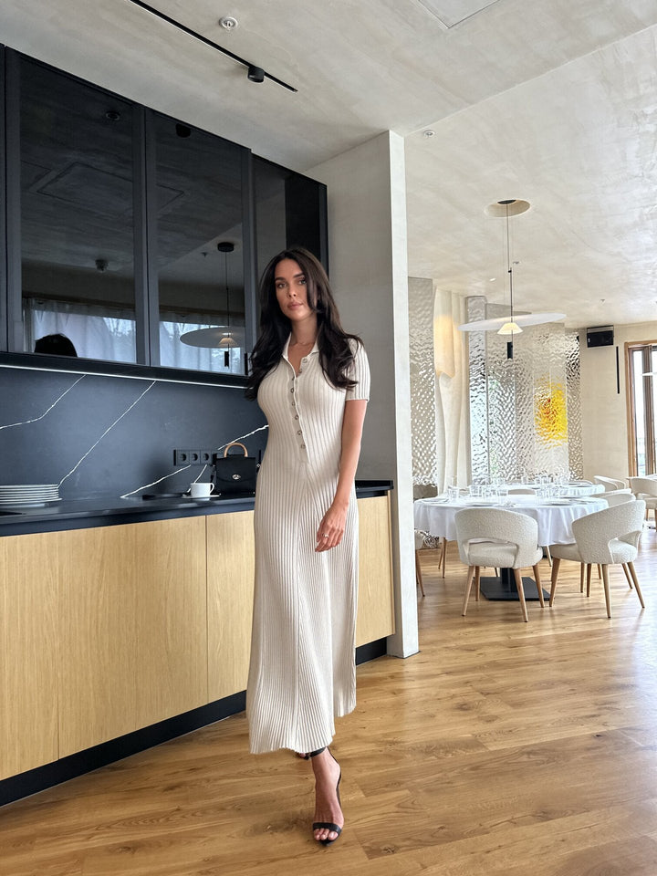 "Women's ribbed knit maxi dress with collared V-neck, button details, and flowing silhouette in versatile colors."