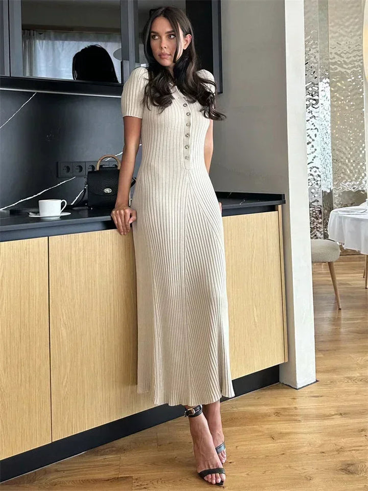 "Women's ribbed knit maxi dress with collared V-neck, button details, and flowing silhouette in versatile colors."