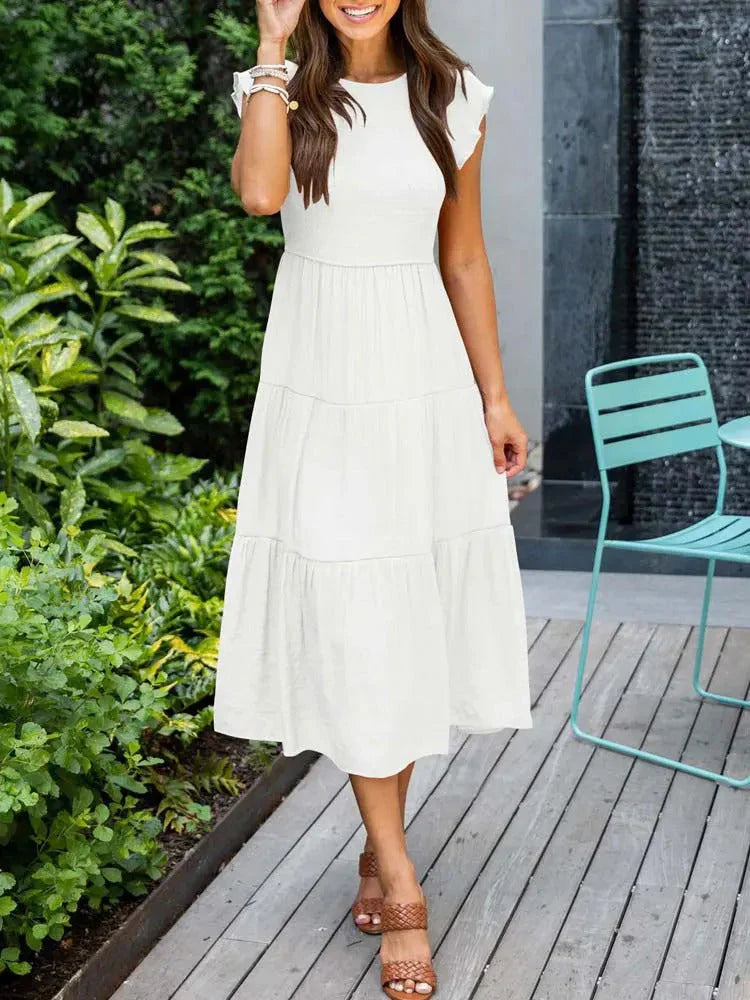 Women's sleeveless smocked midi dress with A-line skirt, airy fabric, perfect for summer occasions. Elegant and comfortable.