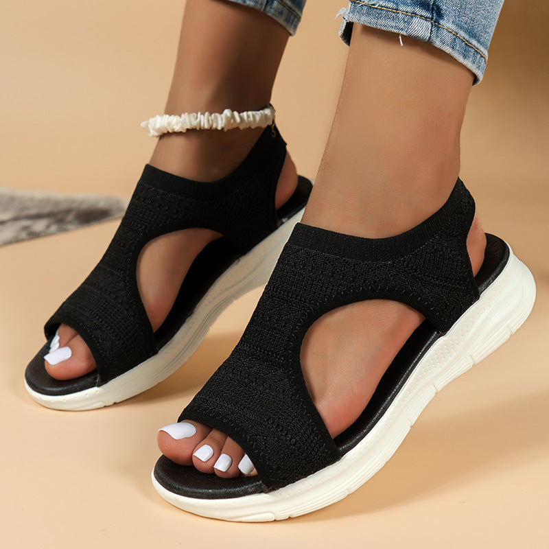 Women's slip-on knit sandals with cushioned sport sole, breathable knit upper, open-toe design; ideal for casual wear.