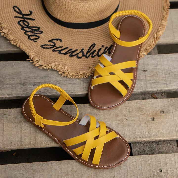 "Women's slip-on sandals with crisscross straps and elastic backband, perfect for comfort and style in casual outings."