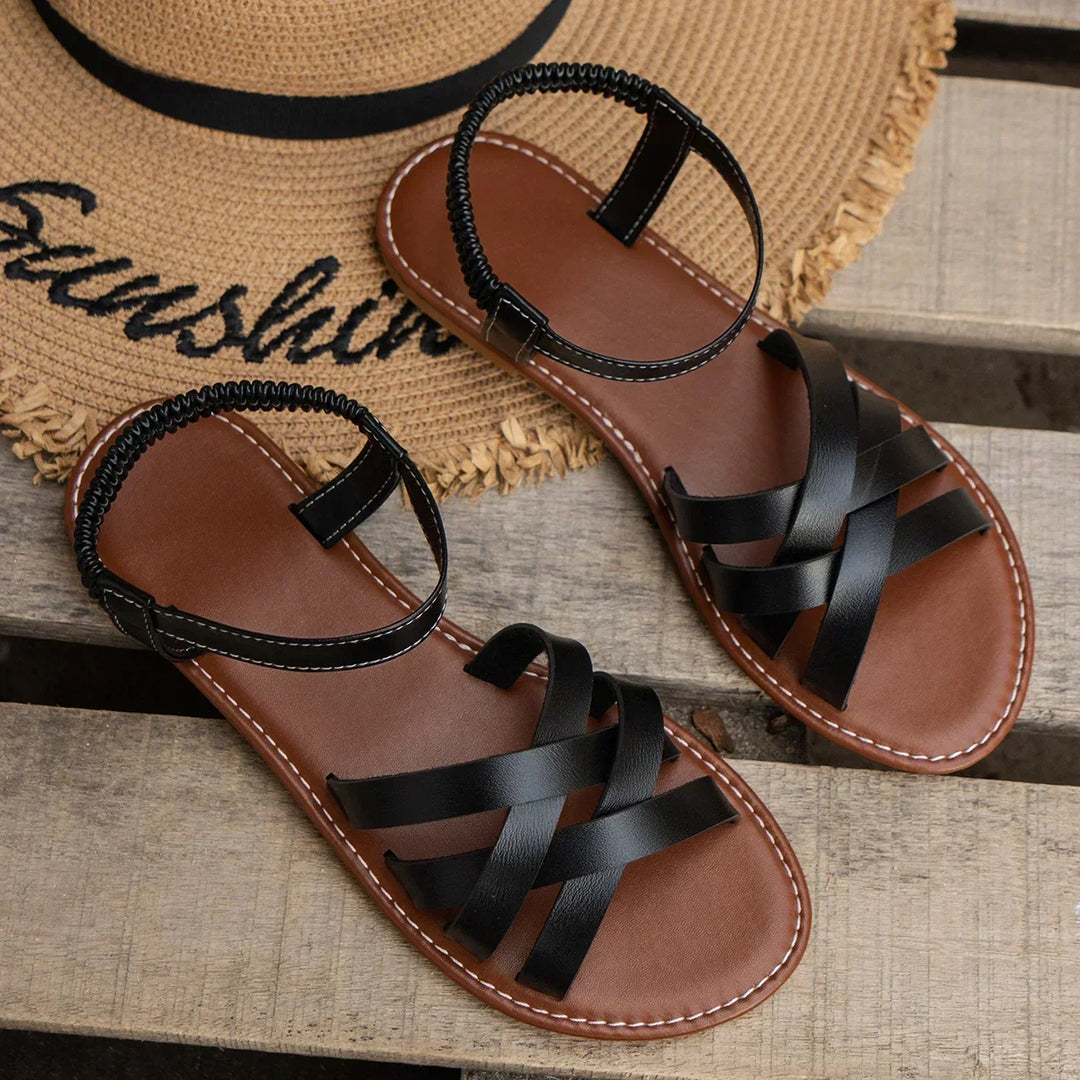 "Women's slip-on sandals with crisscross straps and elastic backband, perfect for comfort and style in casual outings."