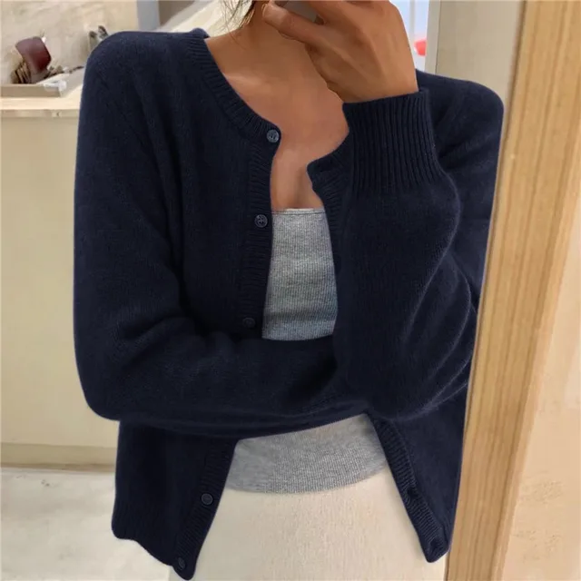 Women's solid color knit cardigan, soft breathable fabric, stylish minimalist design, versatile wardrobe essential.