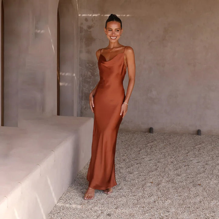 Women's spaghetti strap draped maxi dress, floor-length, fluid neckline, flattering silhouette, ideal for formal events.