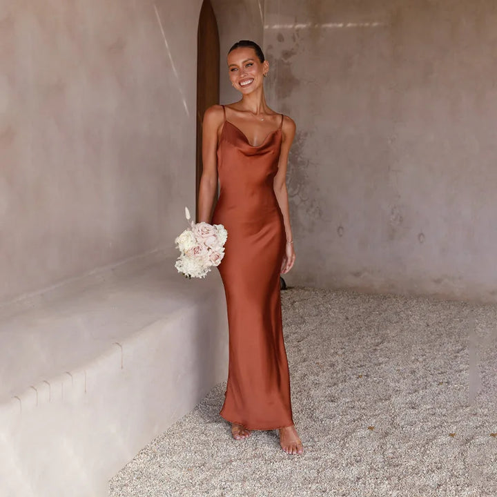 Women's spaghetti strap draped maxi dress, floor-length, fluid neckline, flattering silhouette, ideal for formal events.
