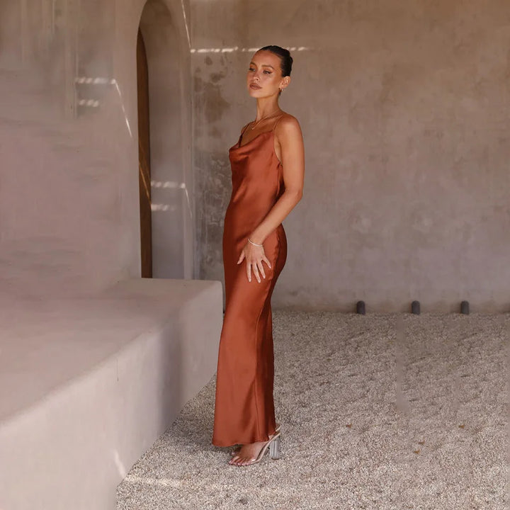 Women's spaghetti strap draped maxi dress, floor-length, fluid neckline, flattering silhouette, ideal for formal events.