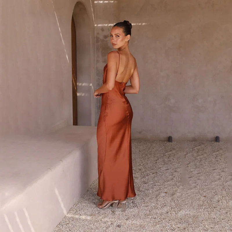 Women's spaghetti strap draped maxi dress, floor-length, fluid neckline, flattering silhouette, ideal for formal events.