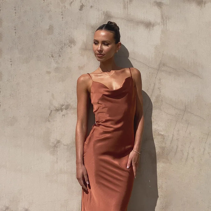 Women's spaghetti strap draped maxi dress, floor-length, fluid neckline, flattering silhouette, ideal for formal events.